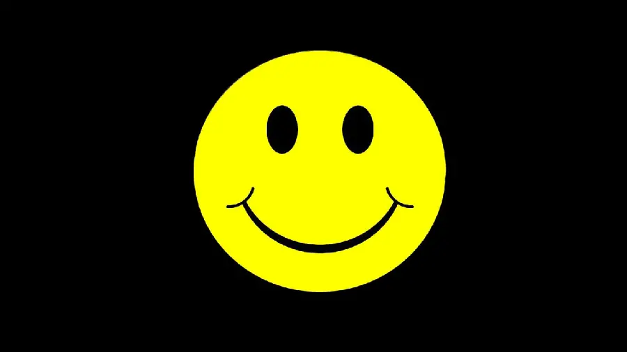 Yellow smiley emoji photo with black eyes on a black background