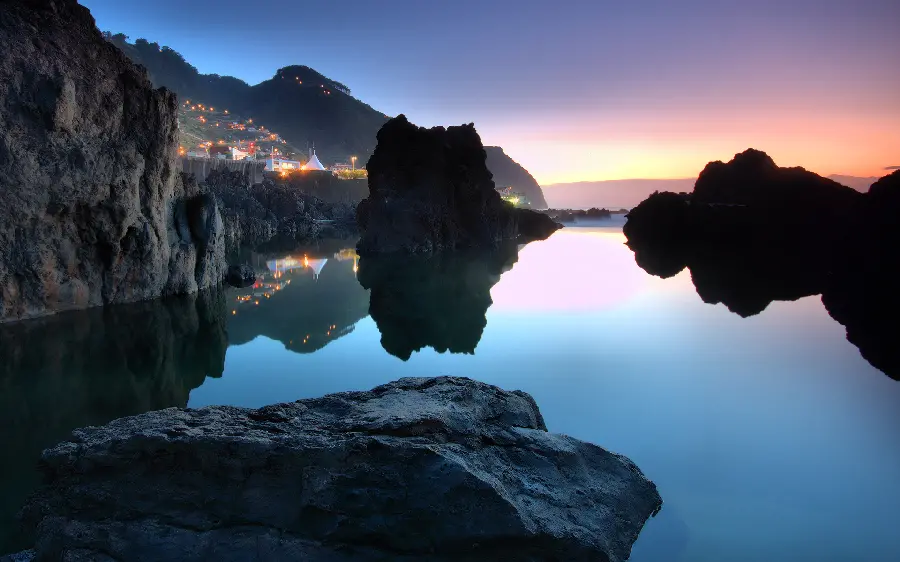  Pictures of a village illuminated at night in nature and incredible black rocks in clear blue