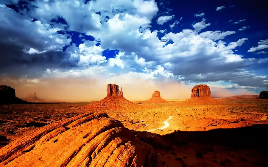 Background photo of cloudy sky and sunlight hitting the rocks of the Arizona desert