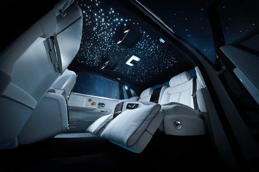 Popular wallpaper of white folding seats and sunroof in a starry night inside a Rolls-Royce