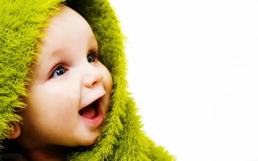Awesome photo of a handsome foreign baby boy with a green blanket 2022