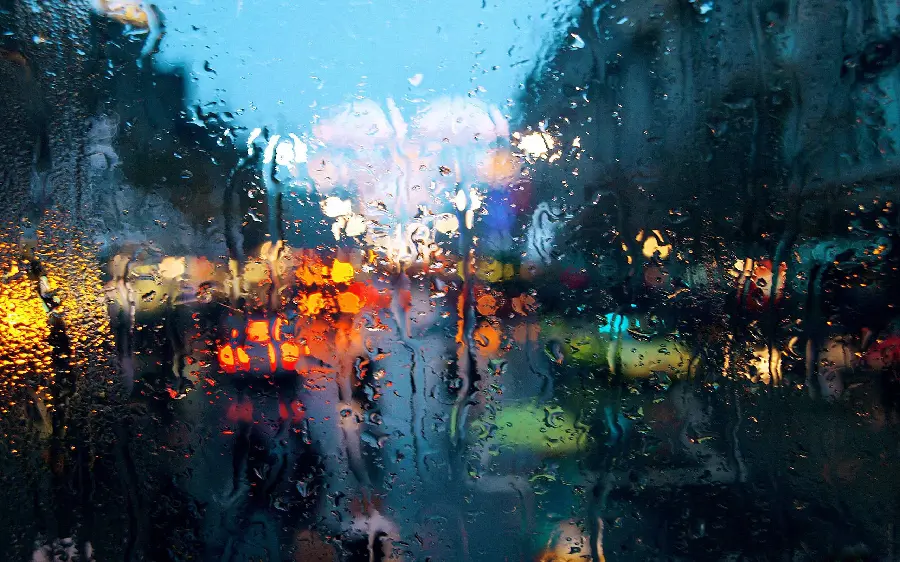 Download Stock Photos Eye-catching rainy city from behind the glass 