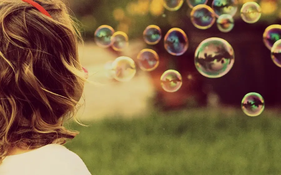 Special and artistic view of a child playing with bubbles in 8K quality