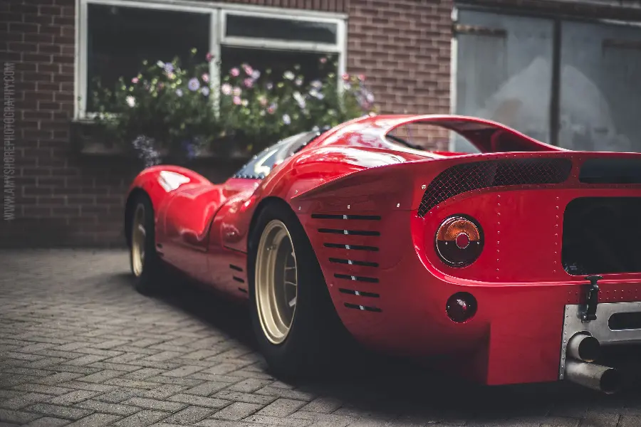 High quality background of a red Ferrari from Hood and left door view with beautiful flowers