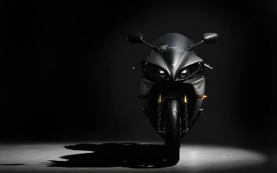 A scary shadowy background photo of a black motorcycle in high quality