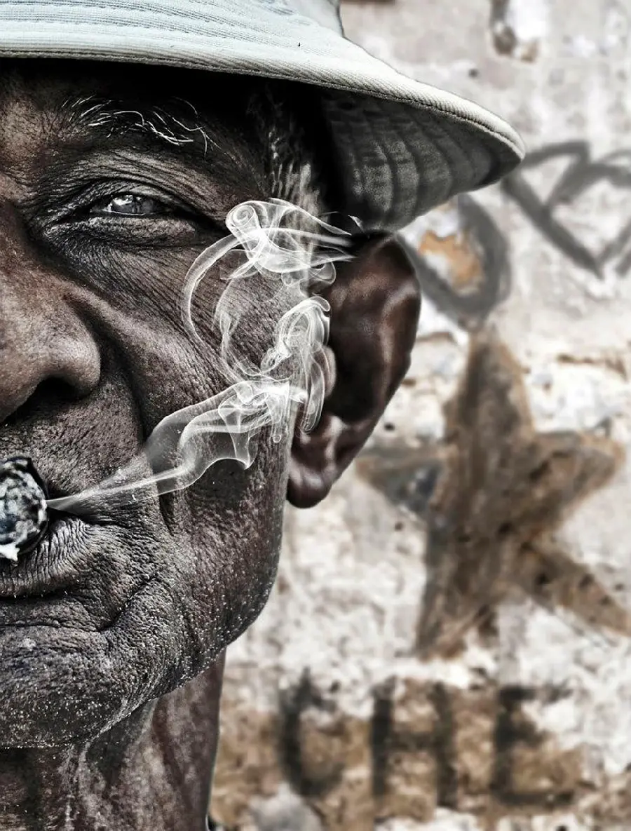 High quality picture of an old man smoking from a unique angle 