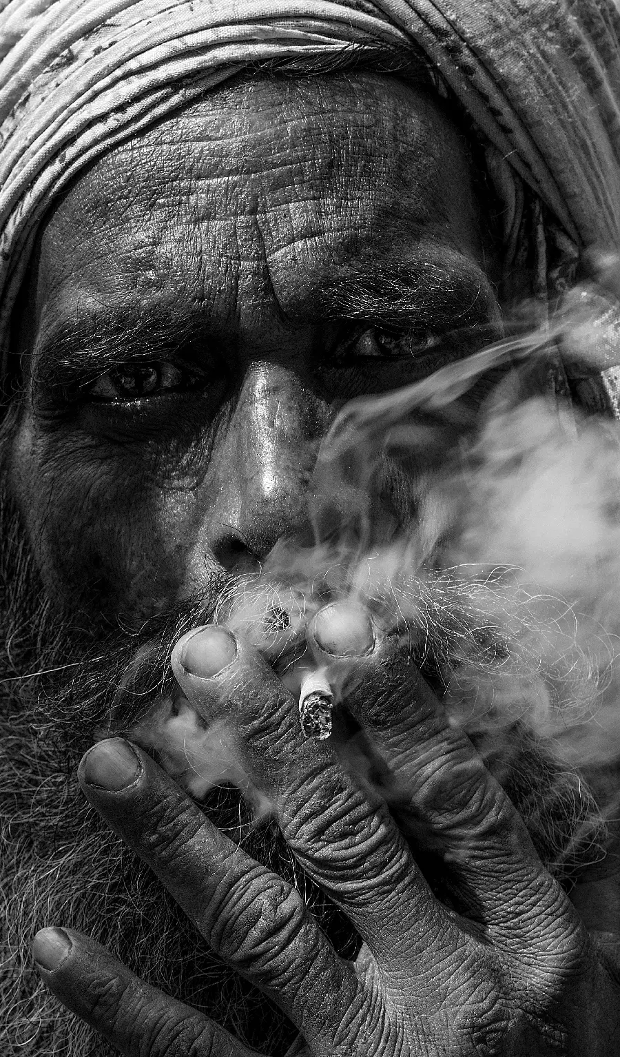 The strangest photo of an old man smoking with interesting black and white details