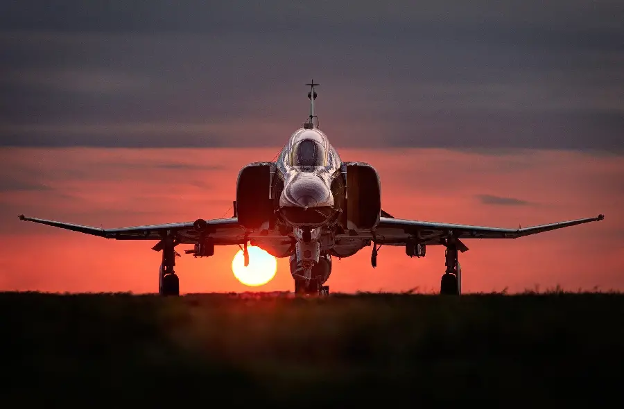 Shining Stock Photo of Military Fighter at Sunset 