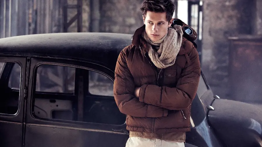 Luxury background of a foreign male model with a warm coat in the winter of 2022