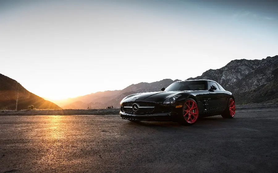 Spiritual background of black Mercedes-Benz with red rims at sunset