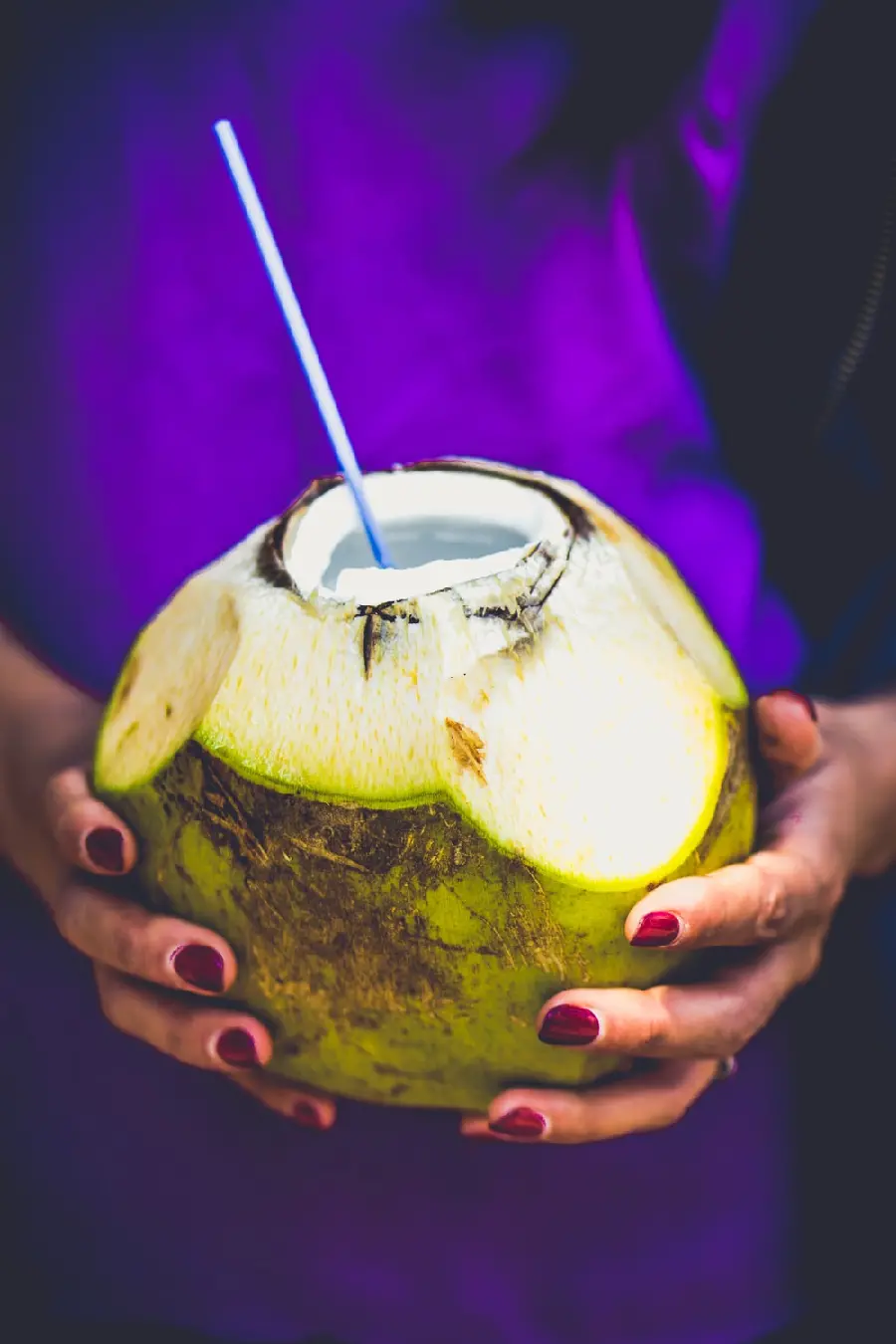 Wallpaper of a coconut drink in a girl's hand in excellent quality for iPhone and Android phones