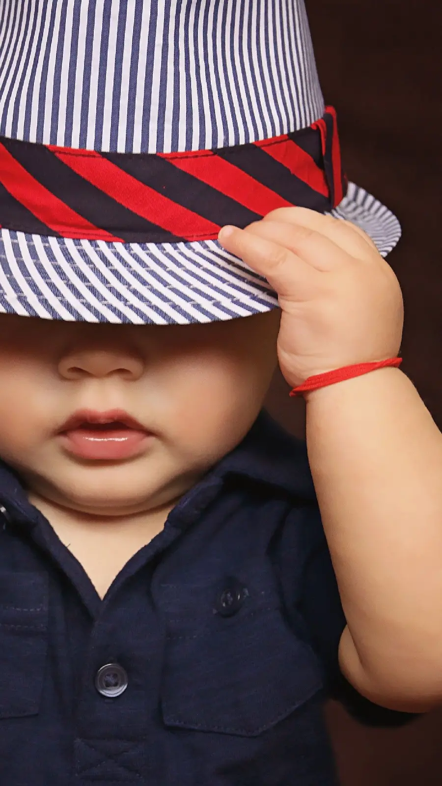 Handsome baby boy in a striped hat 8K