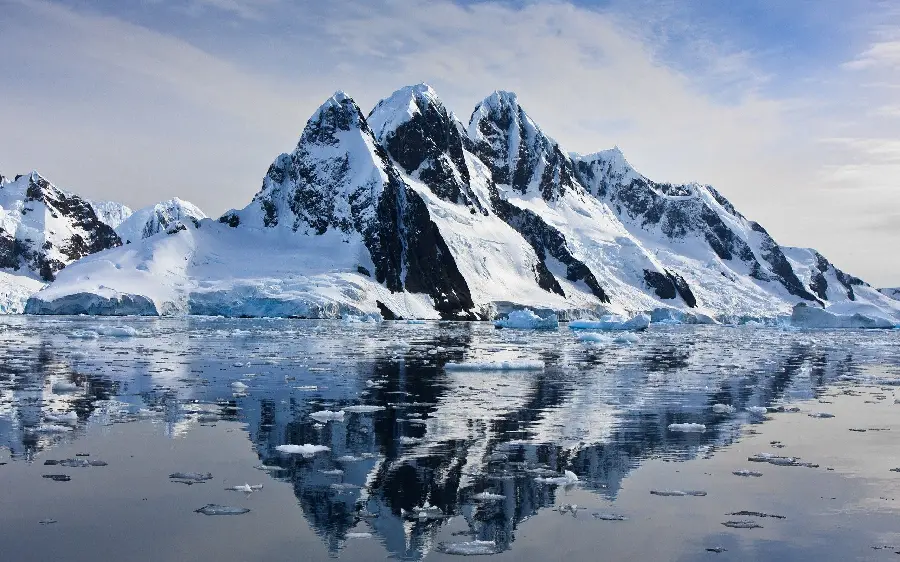 Awesome background of ocean and mountains covered with winter snow in high quality