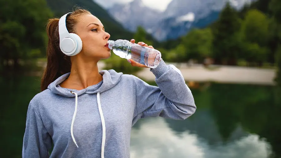 Heartwarming view of an athletic girl drinking water in HD quality 