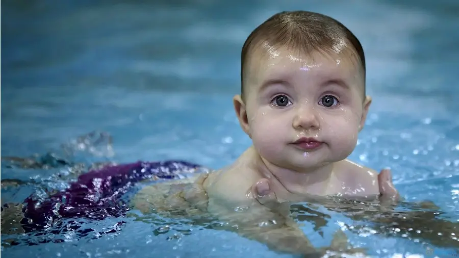 Lovely view of a beautiful baby girl swimming in the pool 2022