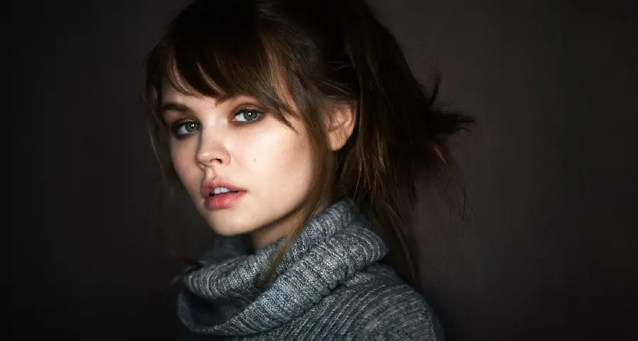 High quality background of a beautiful Russian girl with dark brown hair and a black woven dress special for iPhone phone background