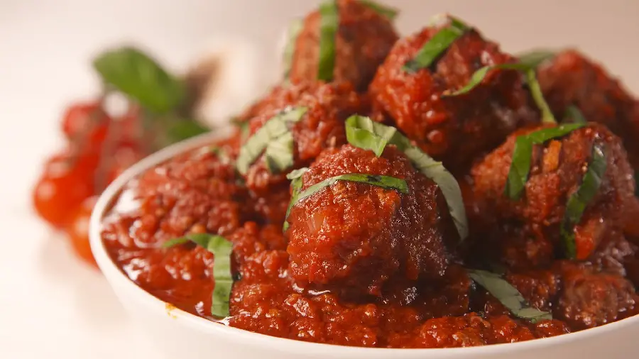 Most viewed high quality stock photo of a soulful food meatball with tomato sauce dipped in it with vegetable strips in a beautiful bowl suitable for WhatsApp