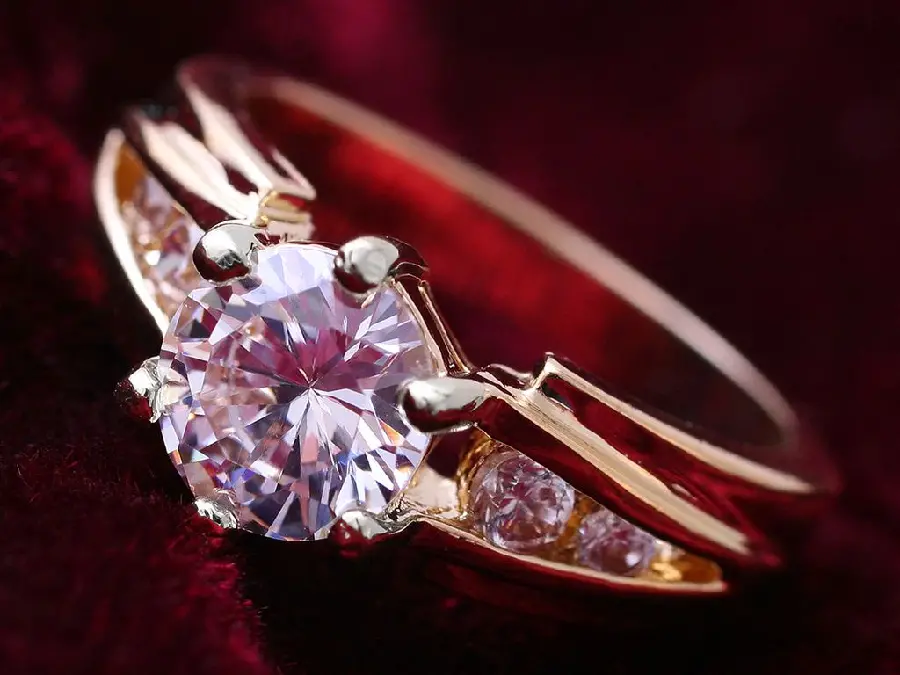 Admirable wallpaper of a gold diamond ring from the left view suitable for the phone