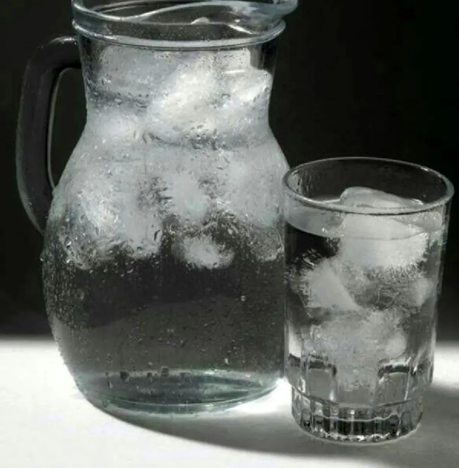 Photo of pitcher and glass of water filled with cool and lovely ice cubes in good quality
