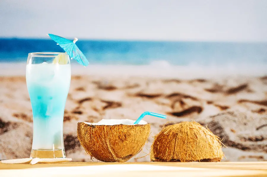 The latest image of a coconut drink with a beach background for your profile in high quality