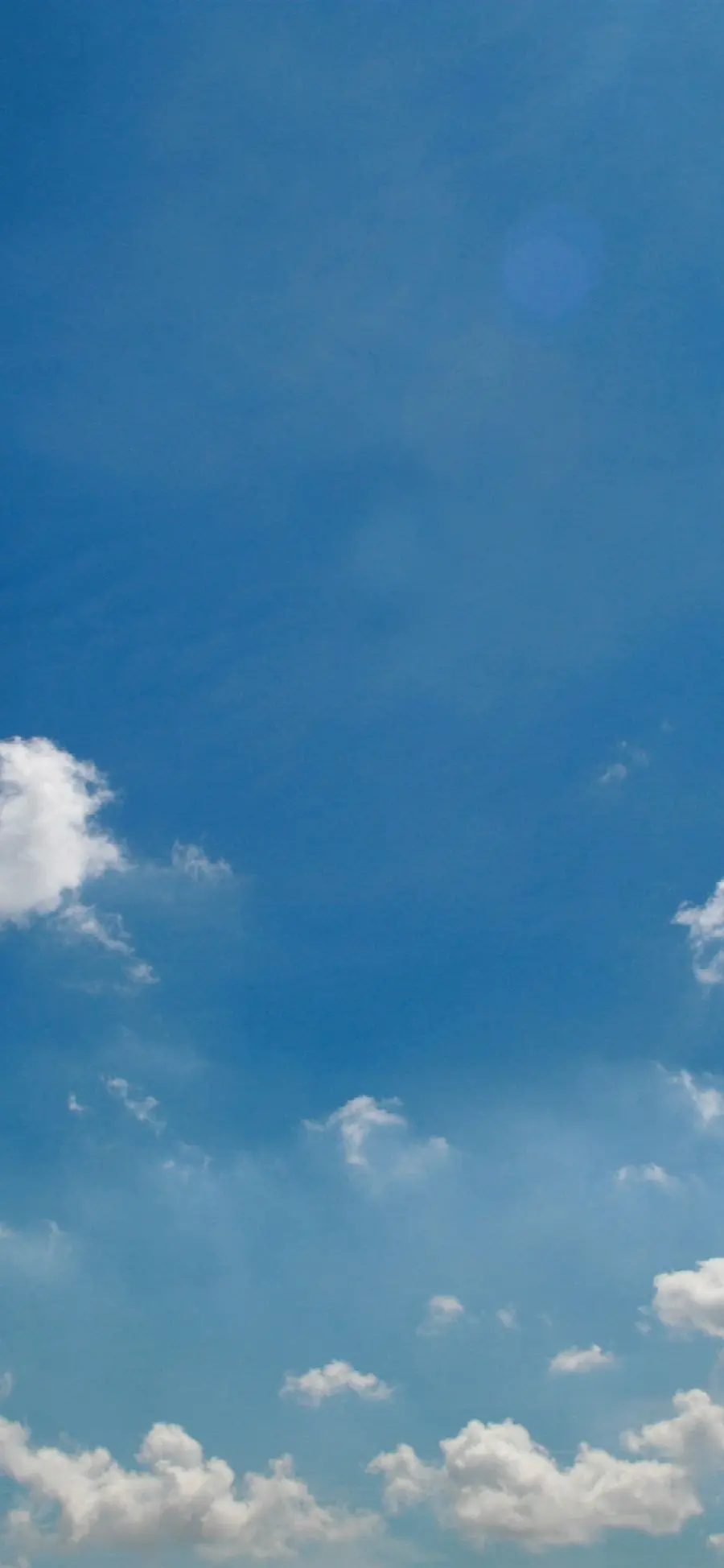 Download a trendy stock photo of a blue sky with a small cloud in HD quality