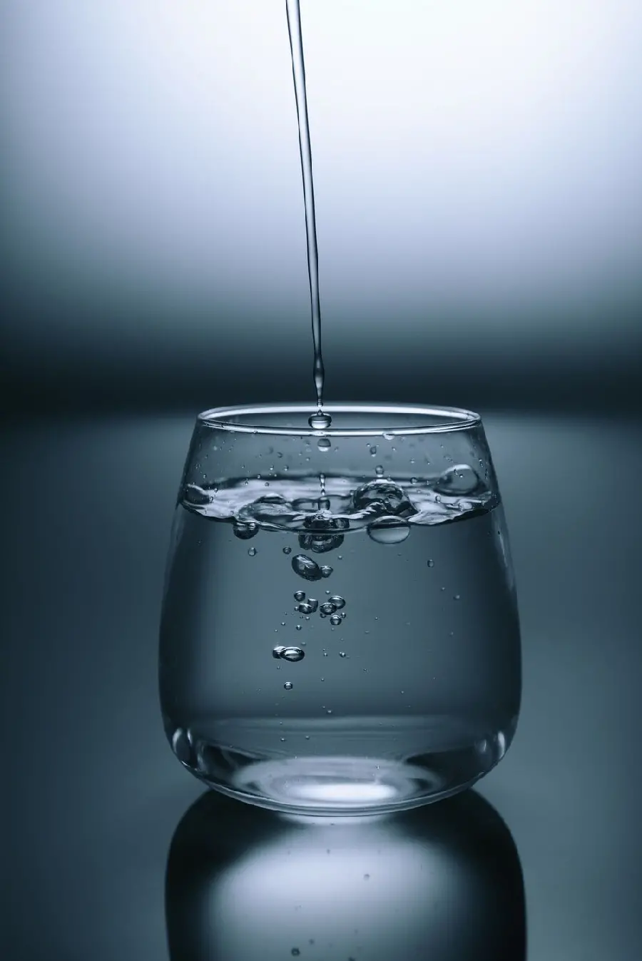 A black and white poster of the moment of drinking water flowing into a small glass