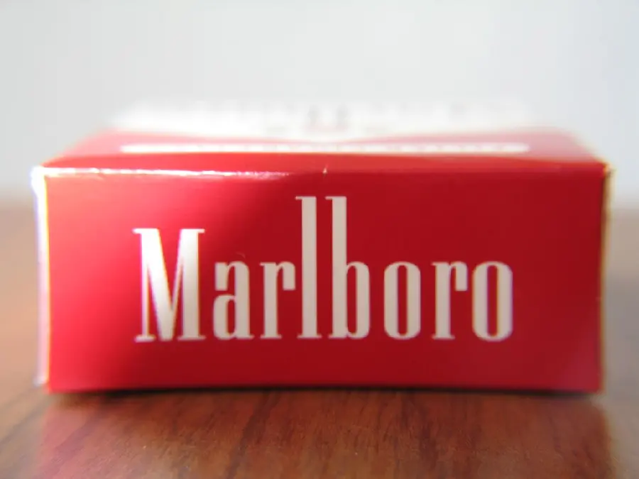 A view of the red part of a Marlboro cigarette with the English inscription Marlboro