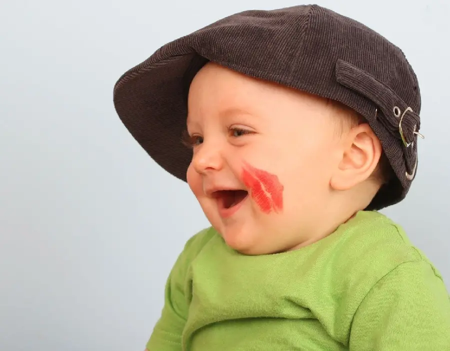 Profile photo of a beautiful and chubby child with a kiss mark on his face