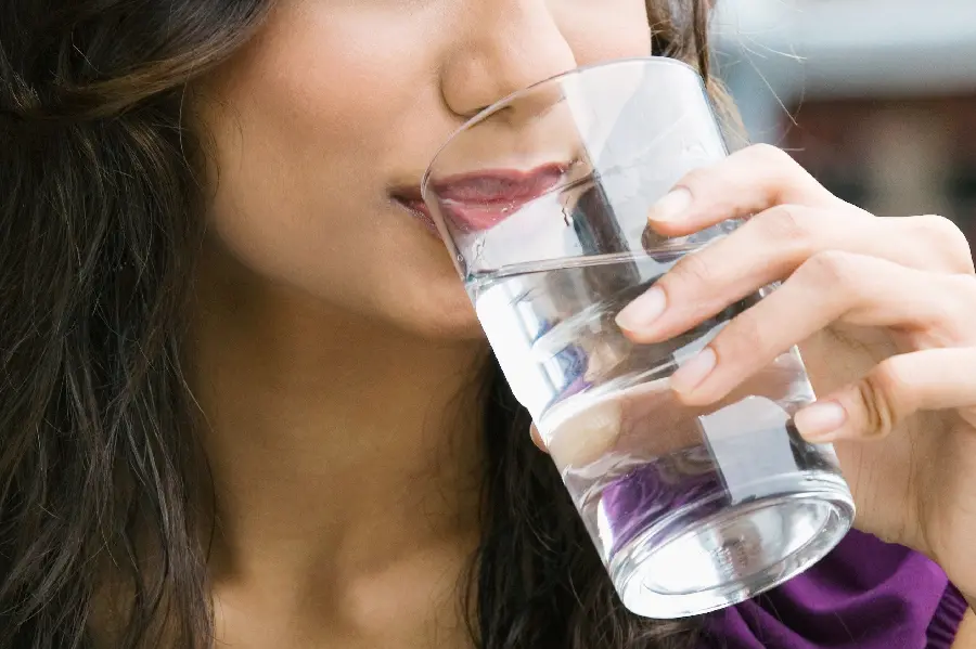Download Stock Photo of Beautiful Girl Drinking Drinking Water from a Glass