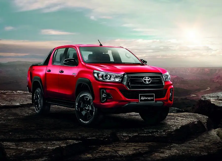 Download a stylish profile of a bright red Toyota Hilux in high quality