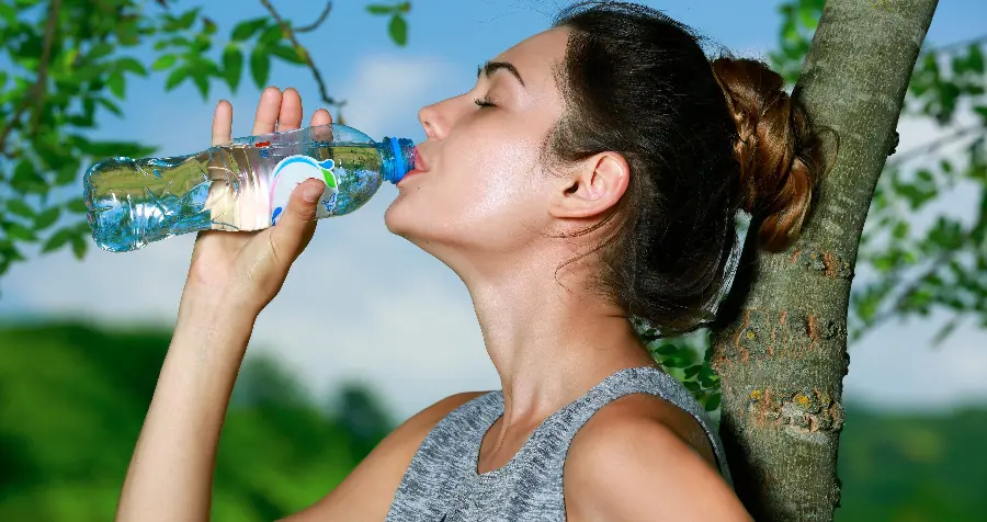 High Quality Photo of an Athletic Girl Drinking Drinking Water Suitable for Phone