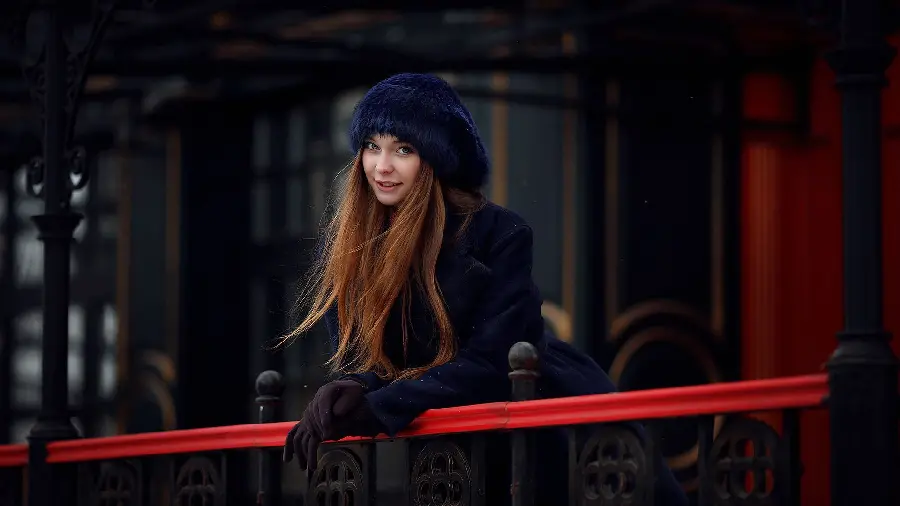 Cute special phone background image of a beautiful Russian girl with a gray hat and brown hair with a special gesture