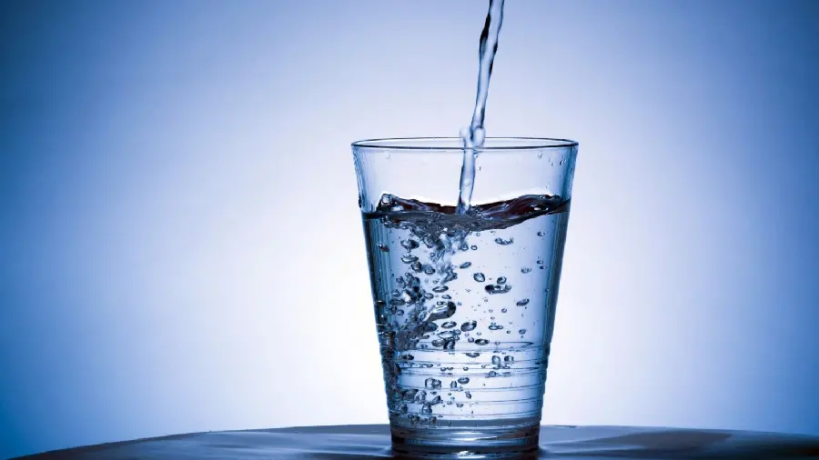 White and blue background, water Drink with lots of bubbles in its glass 