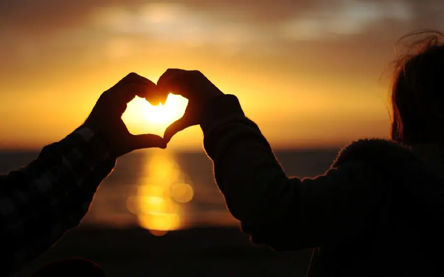 Free download of romantic background of a heart with hands at sunset for laptop and computer 