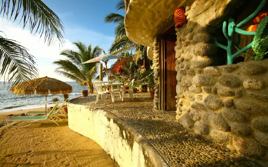 Beautiful photo of a beach house villa and sun loungers with a fresh style and coconut trees in high quality