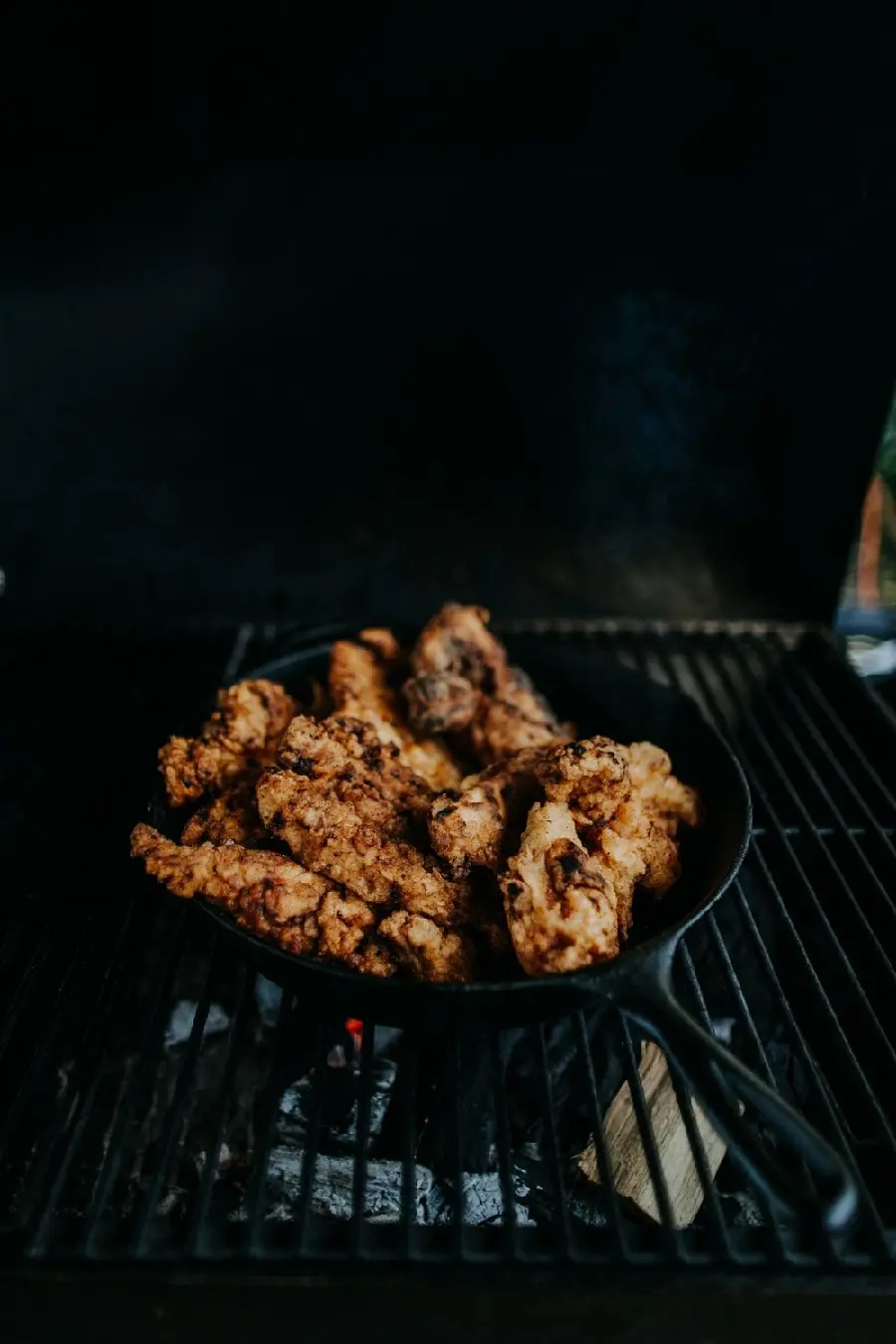 Beautiful background of roasted chicken in a pan and on Fire
