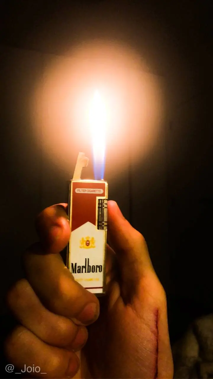 Magical poster of a lit lighter designed to resemble a Marlboro cigarette box