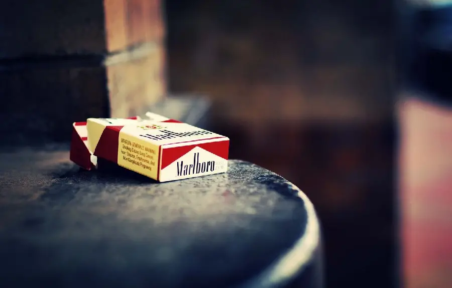 A normal stock image of an empty Marlboro cigarette box on an unknown surface