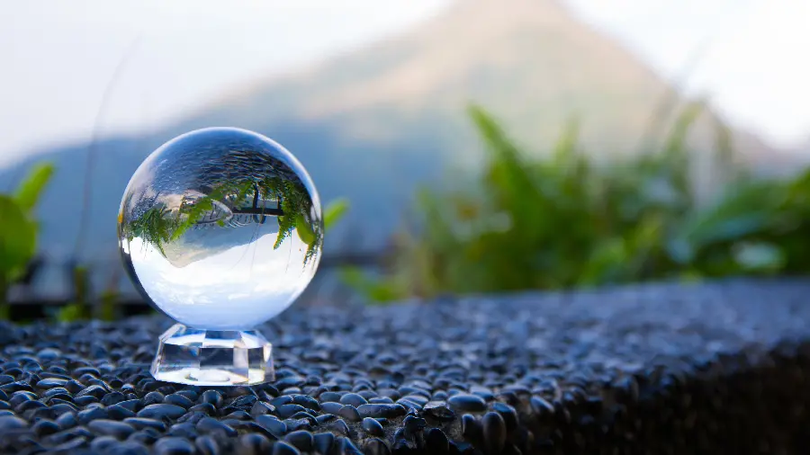 Download popular and fresh image of lush mountains in nature with a glass ball suitable for phone wallpaper