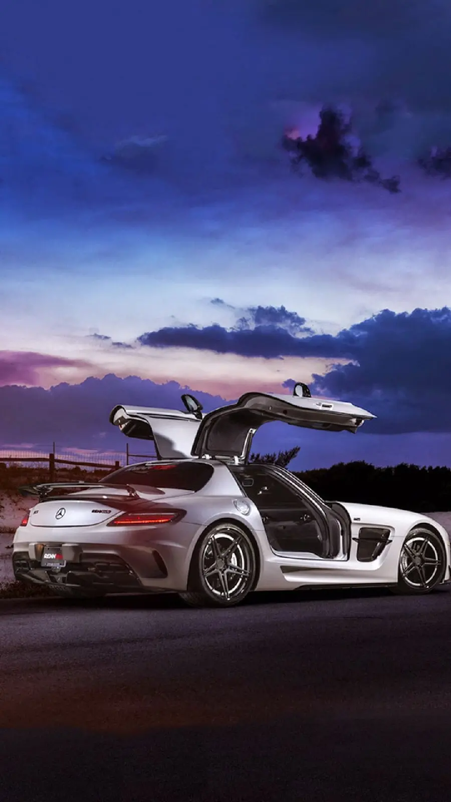 Download the background image of a white Mercedes-Benz from the left view at sunset