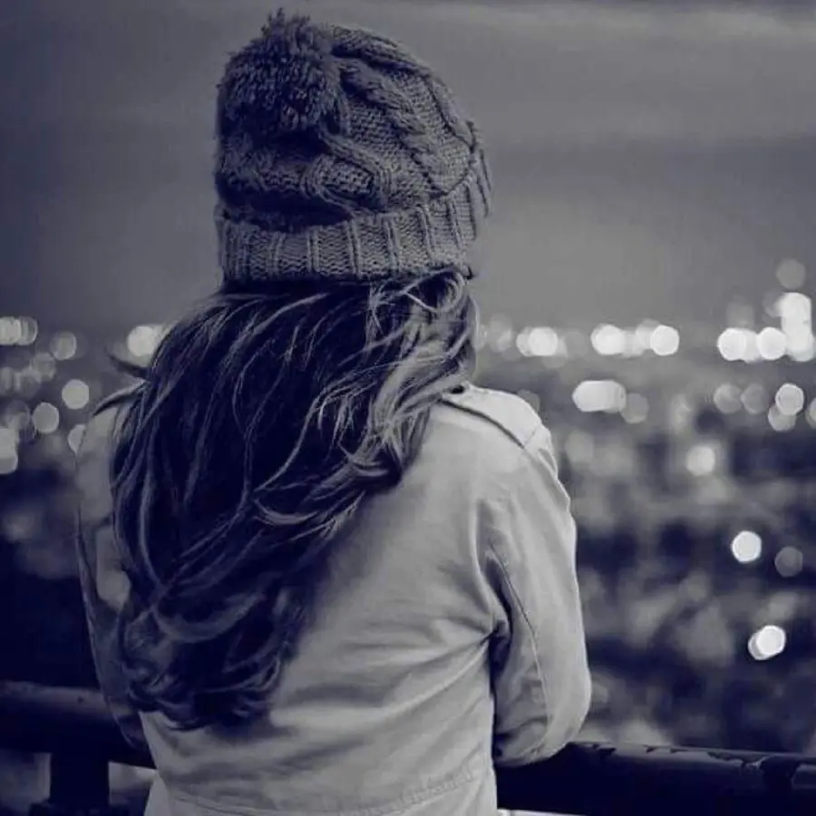 A sad girly profile photo of a girl in the city with a dark theme