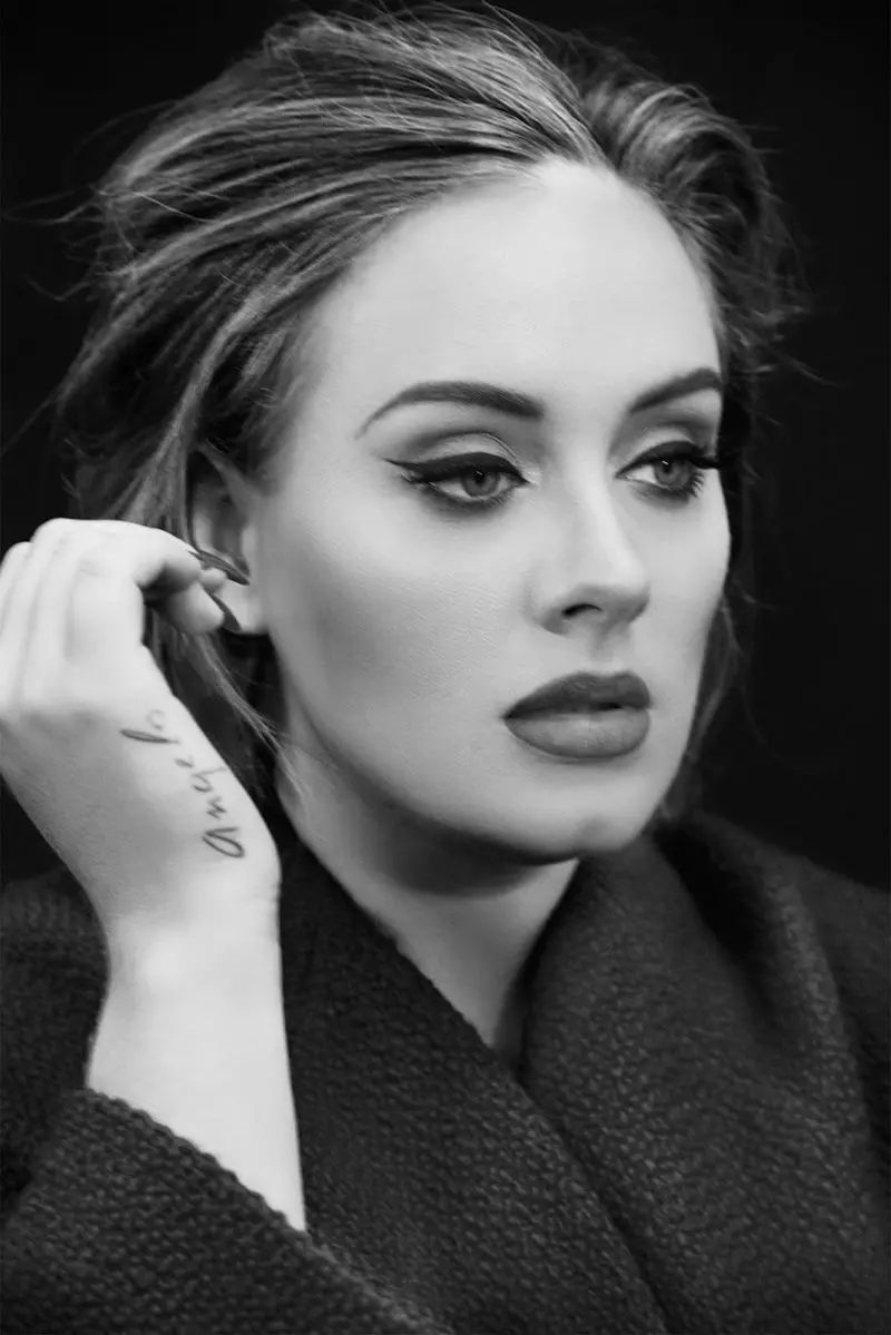 Admirable black and white poster of British singer Adele with eyeliner and tattoo on her hand