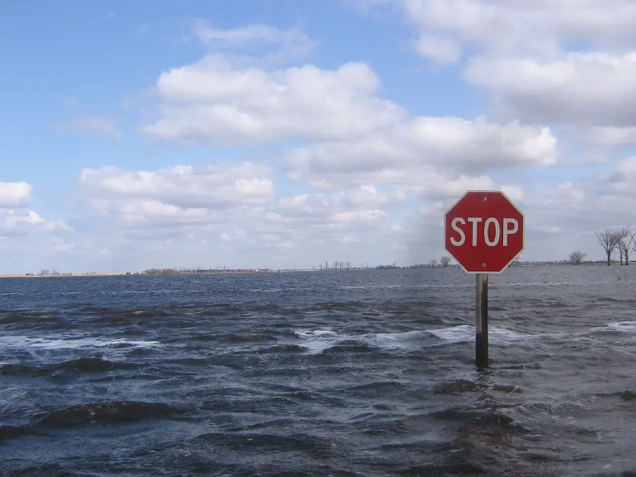 Strange and unique image of a stop sign in the middle of the sea in high quality