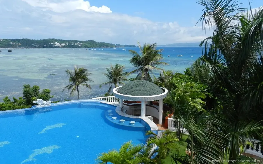 Download magnificent stock photo of a sunny beach house and villa with a large forest next to it in hd quality