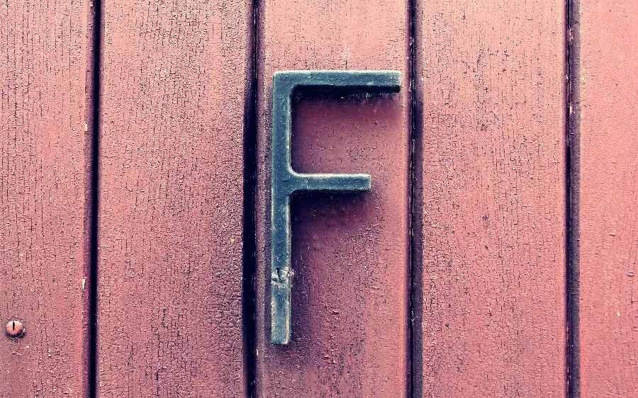 Awesome photo of five iron pillars and an iron letter F installed on it