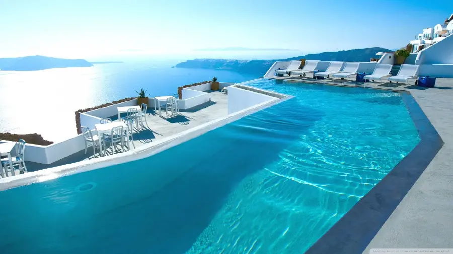 Beautiful view of luxury hotels with swimming pools and entertainment areas in Santorini