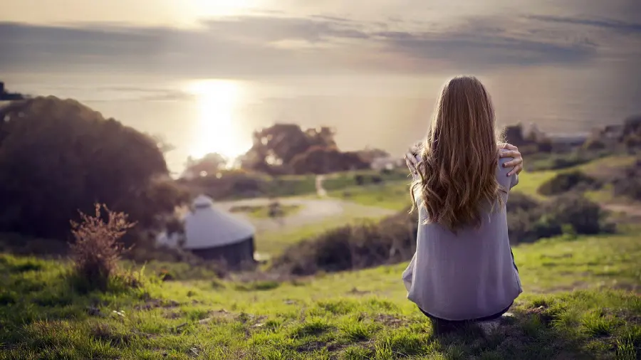 Download Photo of Lonely Girl Watching Sunset from Behind