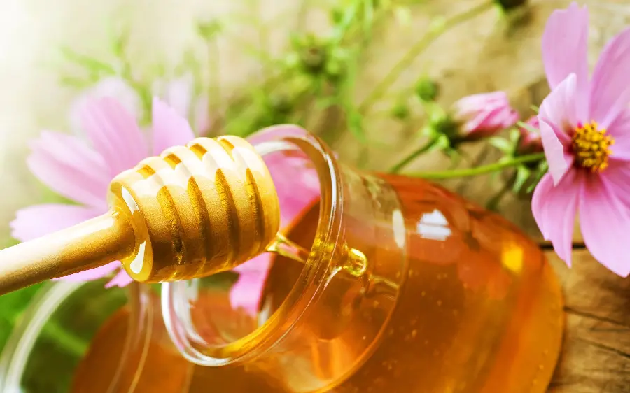 A dreamy image of colorful and delicious honey amidst pleasant nature in 8k quality