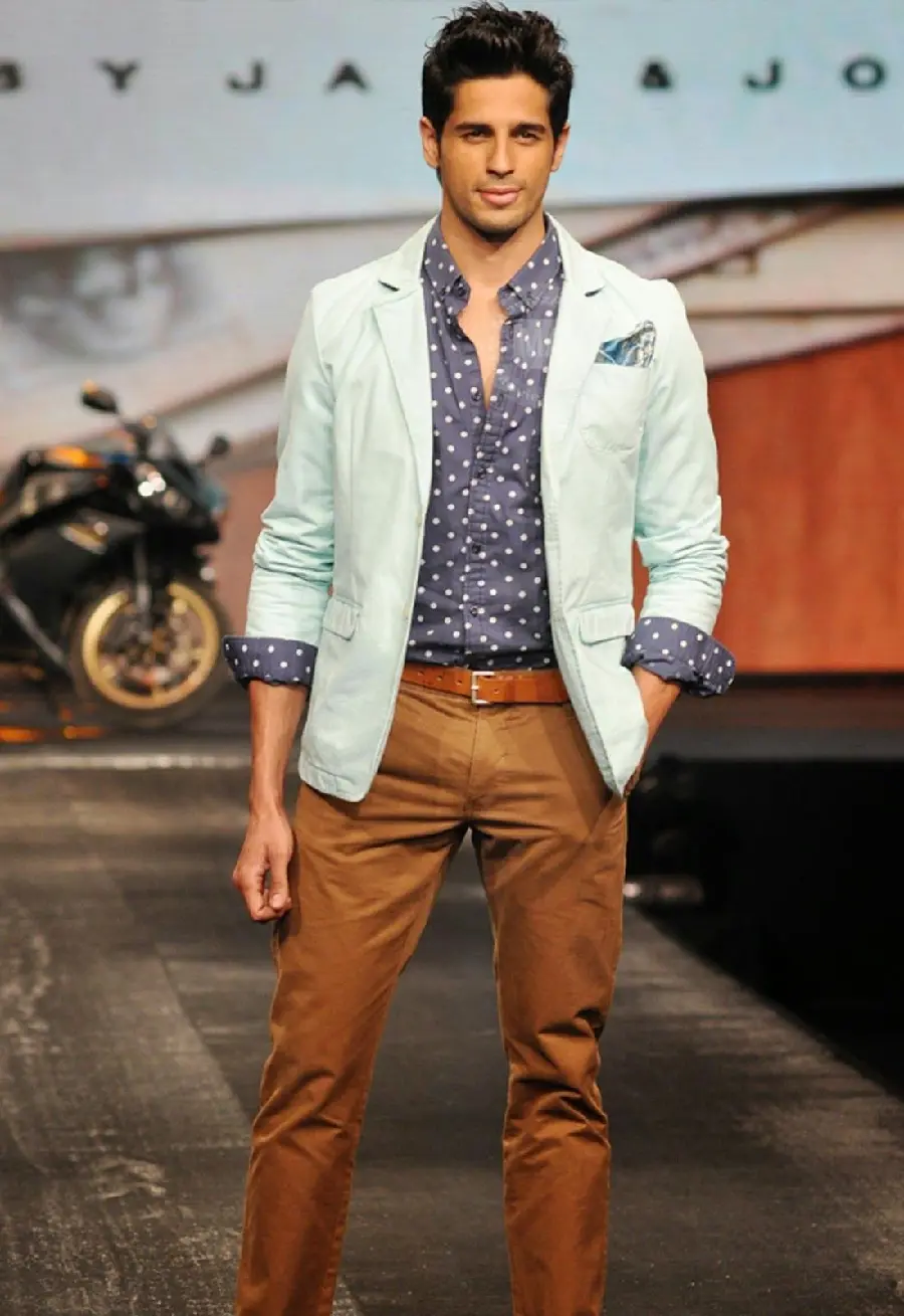 Profile shot of a foreign male model wearing a suit and trousers 2022