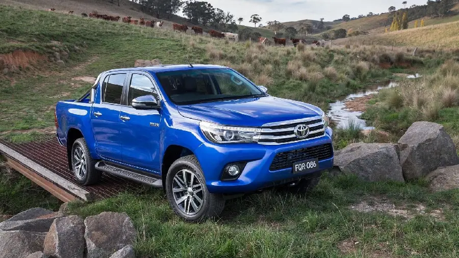 Most viewed background of a cool blue Toyota Hilux on a beautiful river on a bridge